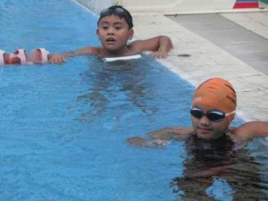 Marc Bryan Dula (top) and Micaela Jasmine Mojdeh receiving instructions from Philippine Swimming League President Susan Papa during training at the Singapore Island Country Club in Singapore. CONTRIBUTED PHOTO