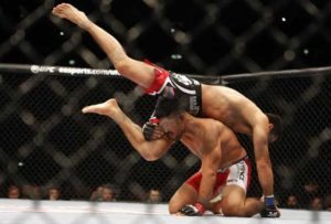 Mixed martial arts competitors US’ Mark Munoz (below) and Dutch Gegard Mousasi fight during the Ultimate Fighting Championship (UFC) Fight Night at the O2 World in Berlin on May 31, 2014.    AFP PHOTO  