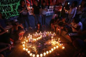 STOP THE KILLINGS Members of women’s groups light candles and offer prayers for victims of drug killings during a vigil held at the Boy Scout Monument in Quezon City. PHOTO BY RUY L. MARTINEZ