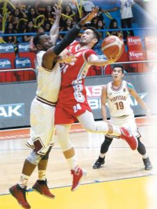 Igee King of EAC drives on Bright Akhuetie during a National Collegiate Athletic Association Season 92 men’s basketball game at The Arena in San Juan City on Tuesday. PHOTO BY RENE H. DILAN