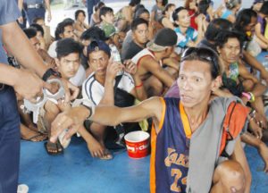 WAR VS DRUGS A total of 67 drug suspects and pushers are seen being guarded by members of the Philippine National Police at the covered court of Camp Caringal in Quezon City, Sept 2, 2016. The suspects were to be transported to the Quezon City Hall of Justice, early Friday morning for inquest. PHOTO BY MIKE DE JUAN