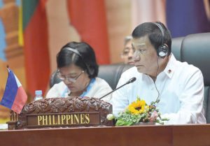 ASEAN DEBUT President Rodrigo Duterte (right) attends the plenary session of the opening ceremony of the Association of Southeast Asian Nations (Asean) Summit in Vientiane on Tuesday. AFP PHOTO BY ROSLAN RAHMAN 