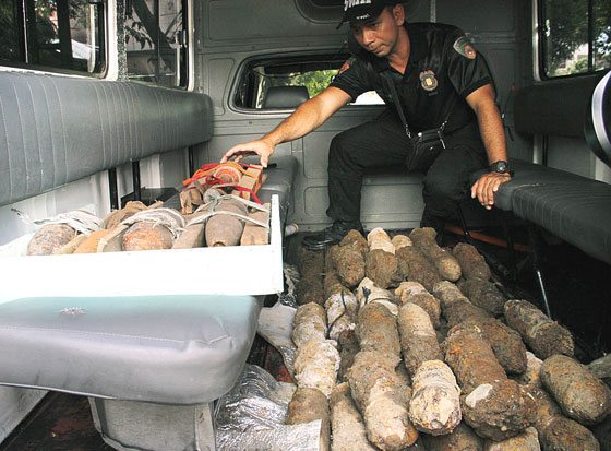 Marikina City police chief Lorenzo Holanday Jr. inspects the 55 vintage bombs unearthed at a construction site in Barangay Santo Niño on Saturday. The bombs will be turned over to the Philippine Army for proper disposal. PHOTO BY MIKE DE JUAN 