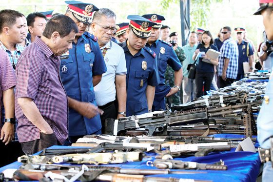 President Rodrigo Duterte looks at firearms seized by the police which were displayed by the Police Regional Office 12 when he visited General Santos City on Friday. CONTRIBUTED PHOTO