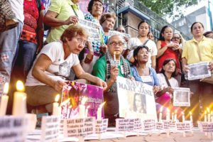 PLEA FOR MERCY Celia Veloso (second from right, seated), mother of Filipina drug convict Mary Jane Veloso who is on death row in Indonesia, joins a candle-lighting ceremony at Philippine Christian University in Manila on Tuesday. A migrant workers’ group organized the event after it was reported in Jakarta that President Rodrigo Duterte had given his Indonesian counterpart Joko Widodo the go-signal for the execution. PHOTO BY DJ DIOSINA