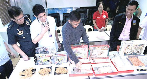 Customs Commissioner Nicanor Faeldon (center) inspects ‘ecstasy’ pills and shabu intercepted by the Bureau of Customs and the Philippine Drug Enforcement Agency at the Manila Central Post Office on Wednesday. Authorities seized five thousand ecstasy pills with an estimated street value of P7.5 million, and an undetermined quantity of shabu. PHOTO BY BOB DUNGO JR. 