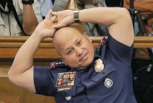 Philippine National Police chief Ronald de la Rosa stretches during the marathon hearing.