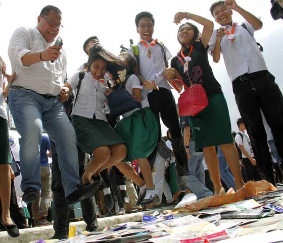 Officials of the Optical Media Board and students of San Francisco High School destroy thousands of pirated DVDs and CDs during a campaign against piracy in Quezon City. PHOTO BY MIKE DE JUAN