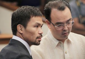 VACANT Senator Emmanuel Pacquiao (left) confers with Senator Alan Peter Cayetano during Monday’s session. Pacquiao moved to declare the entire Senate justice committee, headed by Sen. Leila de Lima, vacant. De Lima was ousted by 16 of her colleagues. PHOTO BY BOB DUNGO JR. 