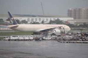 FALSE ALARM  Policemen surround the saudi airline plane which was isolated at the end of the tarmac. Photo By Lanz Mendoza