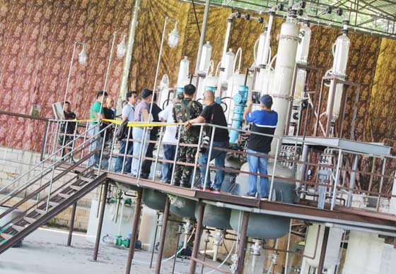 Local officials and the police inspect on Friday what is considered the biggest shabu laboratory uncovered at Barangay Lacquios in Arayat, Pampanga on Thursday. Philippine Drug Enforcement Agency officers said the drug factory can produce 100 kilos of shabu a day. The clandestine shabu laboratory was secured by an eight to 10-foot concrete fence beside a hog farm and a plastics plant.