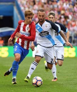 Atletico Madrid’s French forward Antoine Griezmann (left) vies with Deportivo La Coruna’s Brazilian midfielder Guilherme during the Spanish league football match Club Atletico de Madrid vs RC Deportivo de la Coruna at the Vicente Calderon stadium in Madrid on Monday. AFP PHOTO