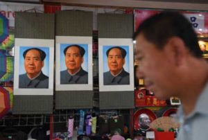 HERO OR VILLAIN A man walks past posters of late communist leader Mao Zedong in a store beside Beijing’s Tiananmen Square on the eve of the 40th anniversary of his death, on Thursday. Today marks the 40th anniversary of the death of Communist China’s founding father Mao Zedong. AFP PHOTO