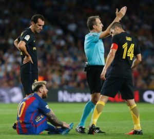 Barcelona’s Argentinian forward Lionel Messi sits on the ground (left) before leaving the pitch during the Spanish league football match FC Barcelona vs Atletico de Madrid at the Camp Nou stadium in Barcelona on Thursday.  AFP PHOTO