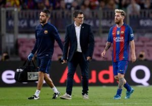Barcelona’s Argentinian forward Lionel Messi (R) leaves the pitch with the team’s doctor after being injured during the Spanish league football match FC Barcelona vs Atletico de Madrid at the Camp Nou stadium in Barcelona on Thursday. AFP PHOTO