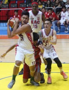 Jervin Guzman (17) of Emilio Aguinaldo College secures the ball against Edcor Marata of Lyceum as EAC teammates Alex Aguas (27) and Hamadou Laminou look on during an NCAA Season 92 men’s basketball game at The Arena in San Juan City on Friday.  PHOTO BY RUY MARTINEZ 