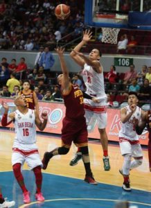 Daryl Singontiko of UPHSD scores against Benedict Adamos of SBC during a semifinals game of the NCAA season 92 men’s basketball tournament at the MOA Arena in Pasay City on Friday. Photo by Russell Palma
