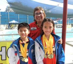 Philippine Swimming League (PSL) President Susan Papa with two young PSL swimmers. CONTRIBUTED PHOTO