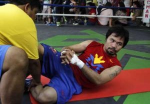 Manny Pacquiao performs abdominal exercise during training. AFP PHOTO