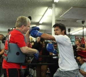 Manny Pacquiao (right) and trainer Freddie Roach work the mitts during a media workout at the Wild Card Boxing Gym. AFP PHOTO