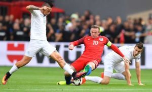 England’s forward Wayne Rooney (center) is tackled by Slovakia’s midfielder Marek Hamsik (left) and Slovakia’s midfielder Jan Gregus during the World Cup 2018 football qualification match between Slovakia and England in Trnava on Monday.  AFP PHOTO 