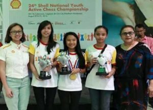 The top lady finishers in the 24th Shell National Youth Active Chess Championship Northern Mindanao leg hold their trophies and prizes as they pose with Shell Philippines executives Melanie Bularan (2nd from left), Social Performance and Social Investment Manager, and Janot Barretto (right), Social Performance Head, during awards rites held at SM CDO Cyberzone in Cagayan de Oro. They are (from left) senior’s top female Janes Caingles of Holy Cross of Davao; junior’s top female Mary Joy Tan of Jasaan National High School; and kiddies’ winner Regina Catherine Quinanola of Malabuyoc Central School. CONTRIBUTED PHOTO