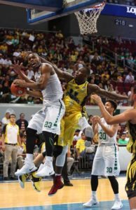 Ben Mbala of DLSU scores against William Afoakwah of UST during an elimination round game of the UAAP men’s basketball tournament at Mall of Asia Arena in Pasay City. PHOTO BY RUSSELL PALMA