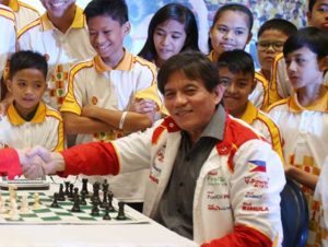 Grandmaster (GM) Eugene Torre (right) with young chess players. CONTRIBUTED PHOTO 