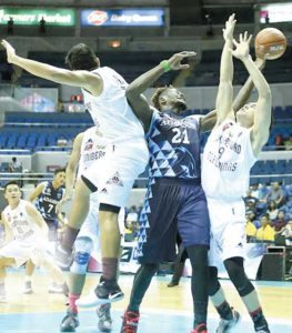 Papi Sarr of Adamson University battles for the rebound against University of the Philippines players during the University Athletic Association of the Philippines Season 79 men’s basketball tournament on Sunday at the Araneta Coliseum.  BOB DUNGO JR. 