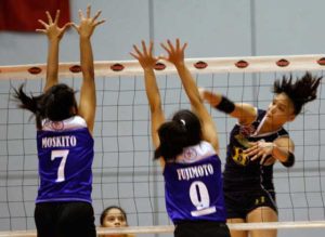 National University’s Faith Nisperos fires a crosscourt attack against two defenders.  FILE PHOTO