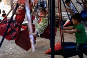 Syrian children play on swings, made from the remnants of exploded rockets in the rebel-held town of Douma, on the eastern edges of the capital Damascus on the third day of Eid al-Adha Muslim holiday. AFP PHOTOS 