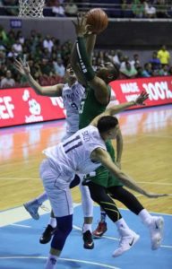 De La Salle University’s Ben Mbala drives against National University’s Matthew Salem and Tzaddy Rangel during the University Athletic Association of the Philippines Season 79 men’s basketball tournament at the Araneta Coliseum. RUSSELL PALM