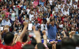 FIST BE WITH YOU President Rodrigo Duterte greets Filipinos at the Hassanal Bolkiah National Sports Complex in Brunei. MALACAÑANG PHOTO 