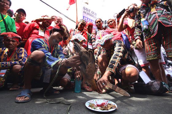  Leaders of indigenous people from the country’s major tribes hold a ritual of condemnation calling for the abolition of the National Commission of Indigenous People outside the NCIP office on West Avenue in Quezon City in a protest on Monday.   They urged President Rodrigo  Duterte to scrap the commission, which they claim is the country’s No. 1 land grabber and plunderer. PHOTO BY RUY L. MARTINEZ 