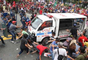 NO QUALMS A police van plows into a group of demonstrators in front of the US embassy on Roxas in Manila. PHOTO BY RENE H. DILAN 