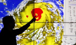 BIGGER THAN ‘YOLANDA’ A weather forecaster points to the eye of Super Typhoon “Lawin” (international name “Haima”), the 12th and so far the strongest cyclone to hit the country this year. It was expected to make landfall in Cagayan or Isabela between 11 p.m. on Wednesday to 2 a.m. on Thursday, and cross Apayao and Ilocos Norte before exiting Philippine territory either Thursday evening or early Friday morning. PHOTO BY MIKE DE JUAN 