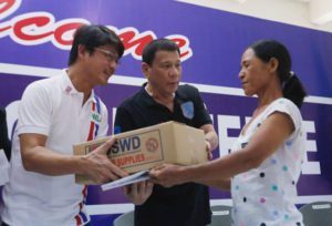 HELPING OUT President Rodrigo Duterte distributes relief goods to a typhoon victim in Tuguegarao City. CONTRIBUTED PHOTO