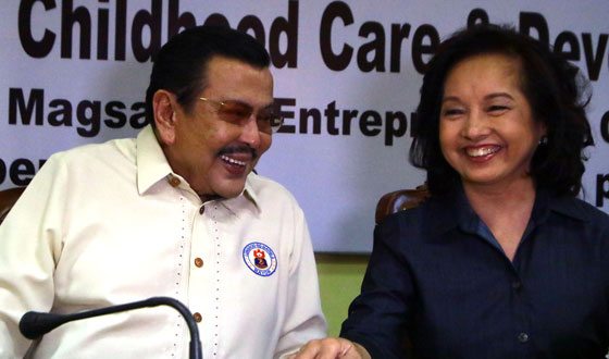 Manila Mayor Joseph Estrada and Pampanga Rep. Gloria Arroyo share a laugh before the signing of a memorandum of agreement on the establishment of a National Child Development Center at the Pamantasan ng Lungsod ng Maynila. PHOTO BY BOB DUNGO JR. 