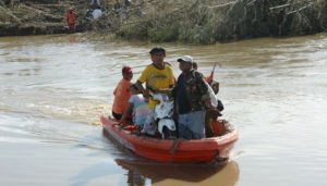 WATERY RIDE Residents ride in a rubber boat across a river after a bridge in their village was destroyed by super Typhoon Lawin (international code name: Haima) in Peñablanca town in Cagayan province in Northern Luzon on Friday. AFP PHOTO