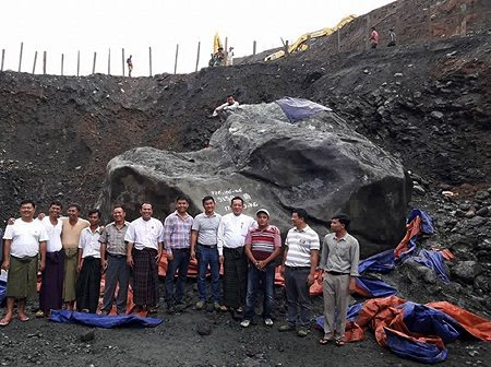 Tint Soe (4R), a lawmaker from the ruling National League for Democracy party is photographed with group of officials and miners next to a giant jade stone at a jade mining site in Hpakant located in Kachine State. AFP PHOTO / MEMBER OF PARLIAMENT TINT SOE 