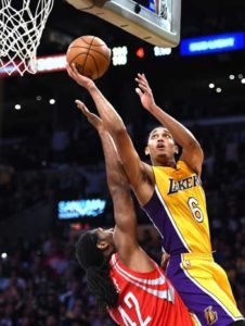 Jordan Clarkson (no.6) of the Los Angeles Lakers scores off of a rebound over Nene Hilario (No.42) of the Houston Rockets at Staples Center on Thursday in Los Angeles, California. AFP PHOTO