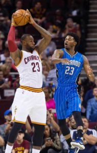 LeBron James No.23 of the Cleveland Cavaliers looks for a pass over C.J. Wilcox No.23 of the Orlando Magic during the first half of a preseason game at Quicken Loans Arena on Thursday in Cleveland, Ohio.  AFP PHOTO