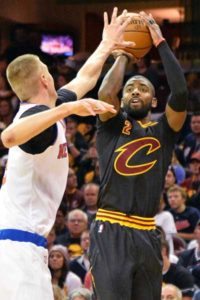 Kyrie Irving No.2 of the Cleveland Cavaliers puts up a jump shot over Kristaps Porzingis No.6 of the New York Knicks in the third quarter on Saturday at Quicken Loans Arena in Cleveland, Ohio. AFP PHOTO