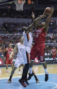 SLAM-BANG Allen Durham of Meralco blocks the shot of Joe Devance of Ginebra during Game 3 of the PBA Governor’s Cup best-of-seven finals at the Araneta Coliseum on Wednesday. PHOTO BY RUSSELL PALMA