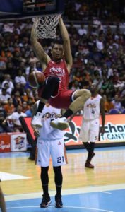 Japeth Aguilar of Ginebra dunks the ball past Reynel Hugnatan of Meralco during Game 5 of the best-of-seven finals of the PBA Governor’s Cup at the Araneta Coliseum on Sunday. PHOTO BY RUSSELL PALMA