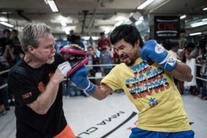Philippine boxing icon Manny Pacquiao (right) works the mitts with trainer Freddie Roach. AFP PHOTO