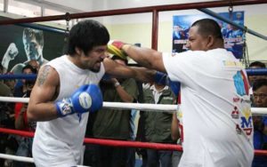 Manny Pacquiao (left) works the mitts with trainer and friend Buboy Fernandez. AFP PHOTO