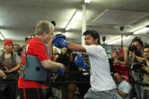 Manny Pacquiao (right) and trainer Freddie Roach work the mitts during a media workout at the Wild Card Boxing Gym in Hollywood, California. AFP PHOTO