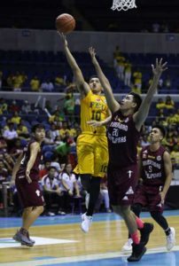 Wendelino Comboy of FEU scores past Jerson Prado of UP during a UAAP men’s basketball tournament at the Araneta Coliseum on Saturday. PHOTO BY RUSSELL PALMA