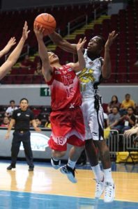 William Afoakwah of UST blocks the shot of Edson Batiller of UE during a UAAP men’s basketball game at Mall of Asia Arena in Pasay City on Saturday. PHOTO BY RUSSELL PALMA